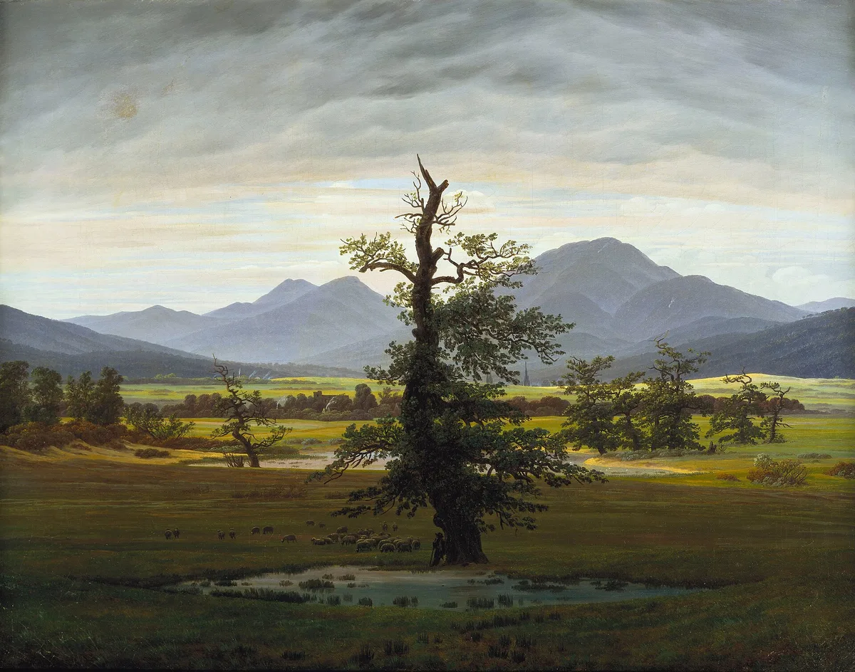 Caspar David Friedrich's The Lonely Tree, 1822, showing atmospheric perspective as dark foreground marsh and oak give way to pale horizon and blue-grey mountains in the distance