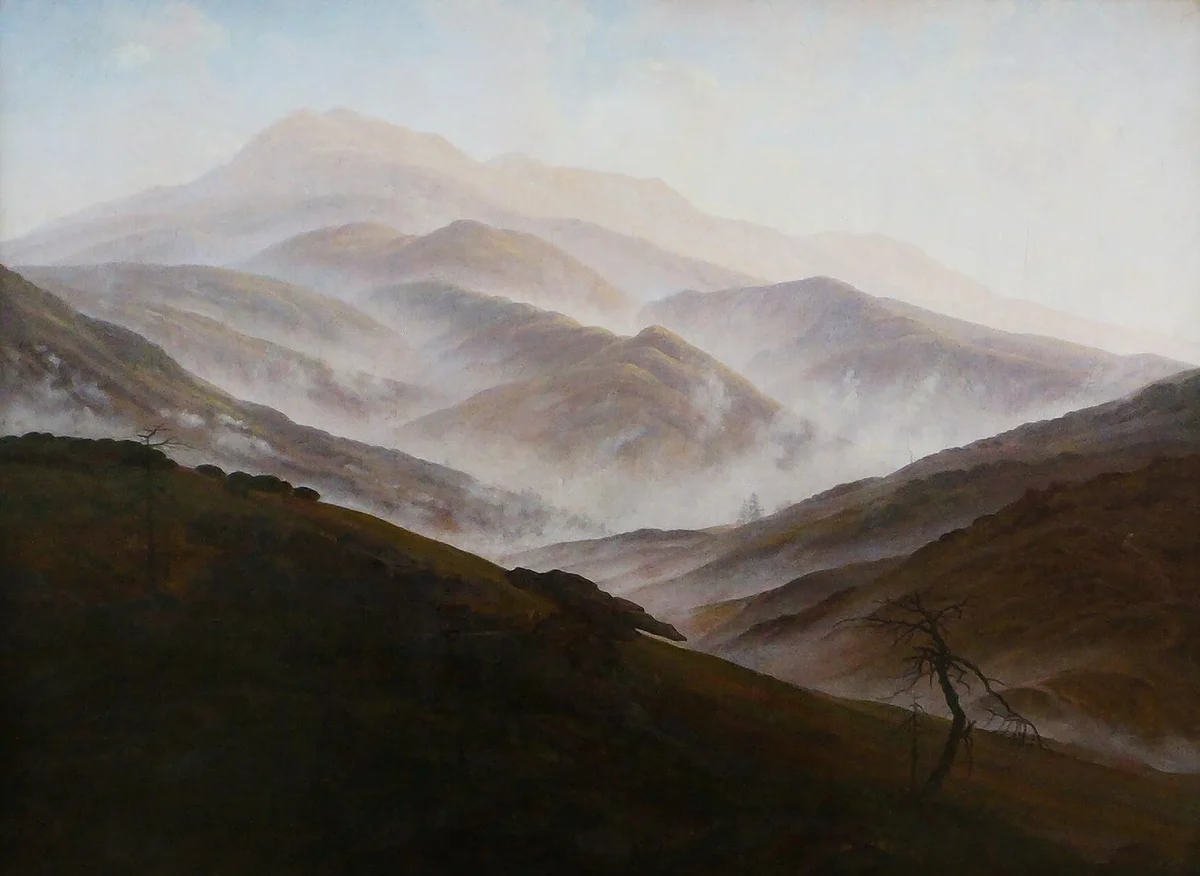 Caspar David Friedrich's Riesengebirge Landscape with Rising Mist showing atmospheric perspective — a near-black foreground slope in front of mountain ridges that grow paler with distance, mist filling the valleys between them